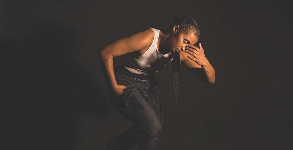 Female dancer in front of a black background