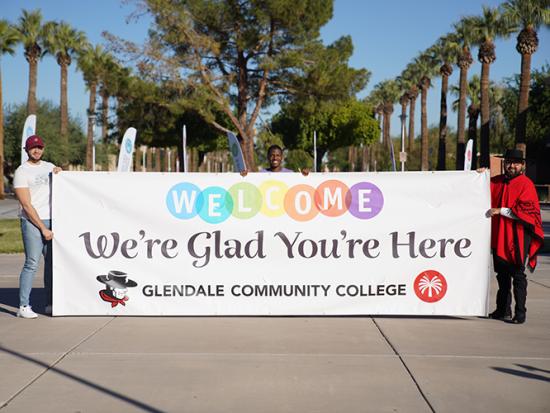 GCC students and the Gaucho holding up a welcome sign.