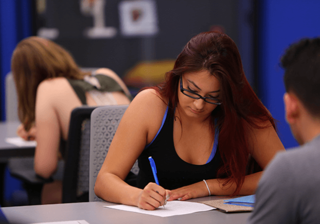 A picture of students studying and taking notes.