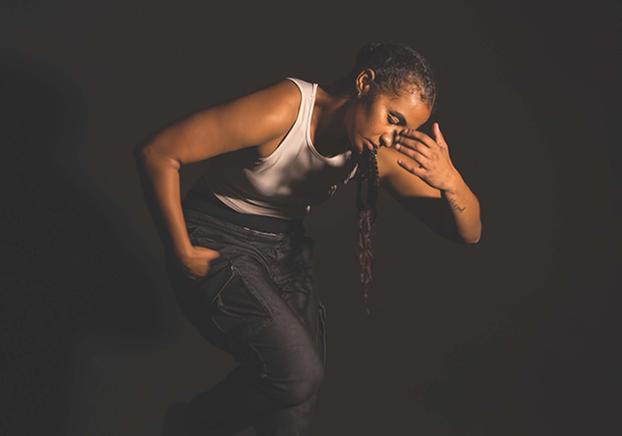 Female dancer in front of a black background