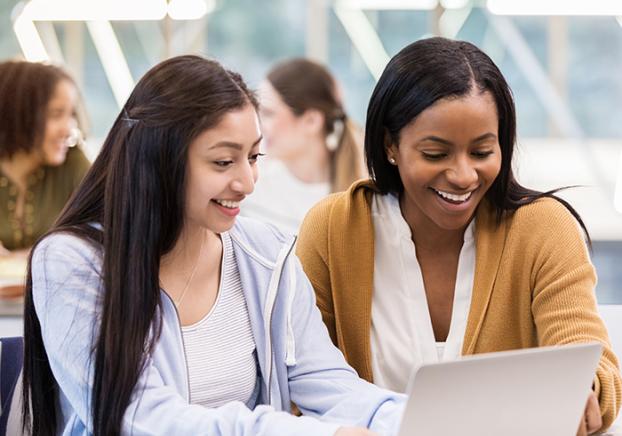 Student and Advisor sitting at a laptop