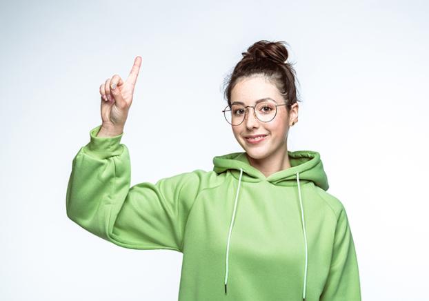 Smiling student with her hand raised.